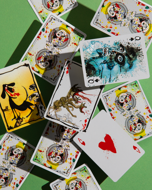 Flying Dog Edition 2 playing cards spread on green surface showing illustrated court cards and abstract ink designs