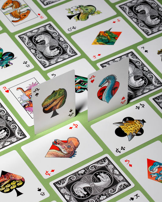 Dinosaur playing cards spread showing multiple illustrated dinosaur cards