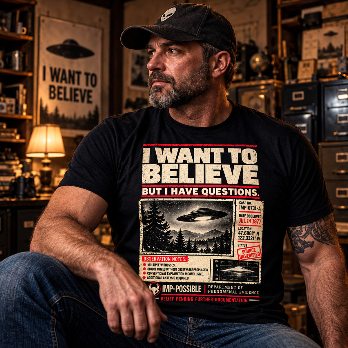 Model wearing the black IMP-POSSIBLE I Want to Believe UFO graphic T-shirt.