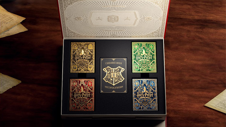Harry Potter playing cards collector box set by theory11 showing Gryffindor, Slytherin, Ravenclaw, and Hufflepuff decks inside a Hogwarts-themed display box