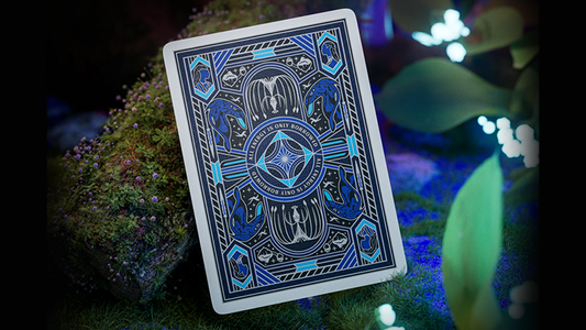 Avatar playing cards by theory11 featuring blue Pandora-inspired card back design displayed on moss in a glowing bioluminescent forest setting