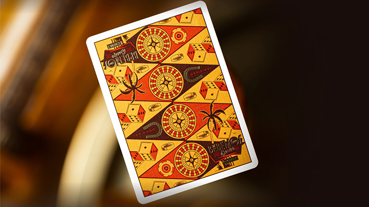 Bebemos Casino playing cards by theory11 featuring retro geometric card back design in red and gold displayed on a warm casino-style background