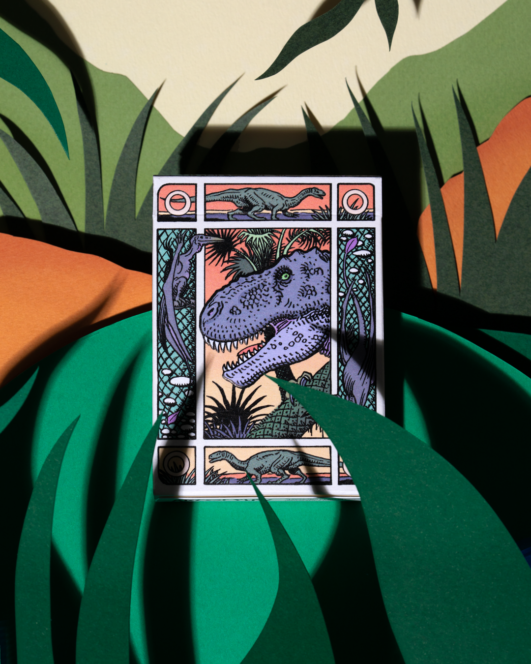 Dinosaur playing cards tuck box featuring illustrated prehistoric artwork by William Stout