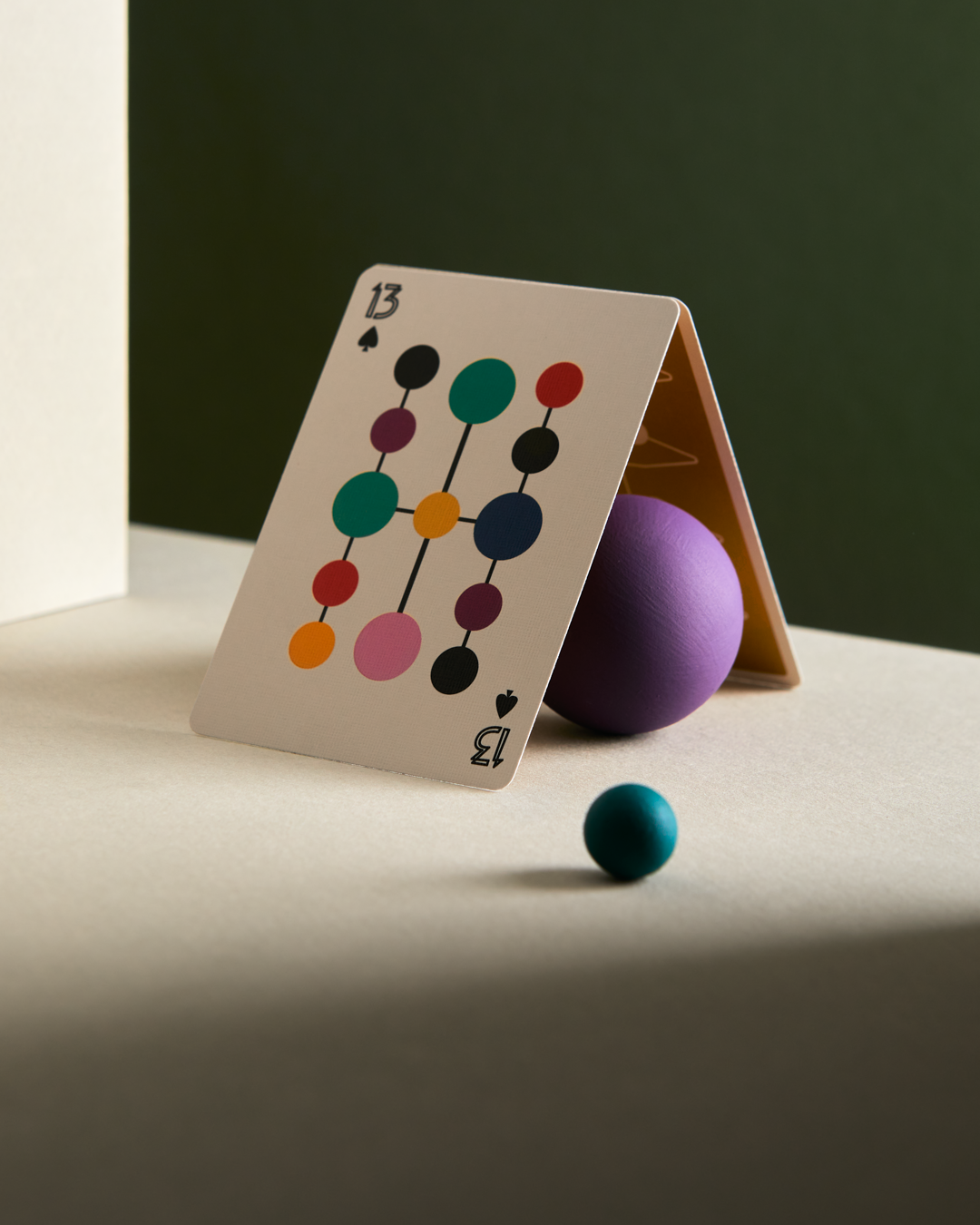 Detailed view of Eames Hang-It-All playing card design with bold color and minimalist layout