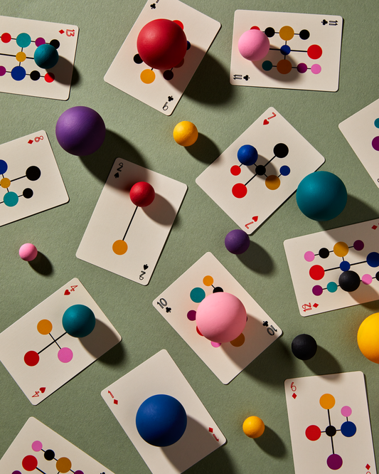 Eames Hang-It-All playing cards spread showing minimalist numbered courts and geometric artwork