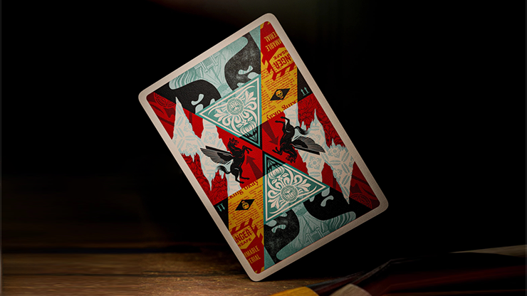 Obey Collage Edition playing cards by theory11 featuring Shepard Fairey collage-style card design displayed on a dark tabletop background