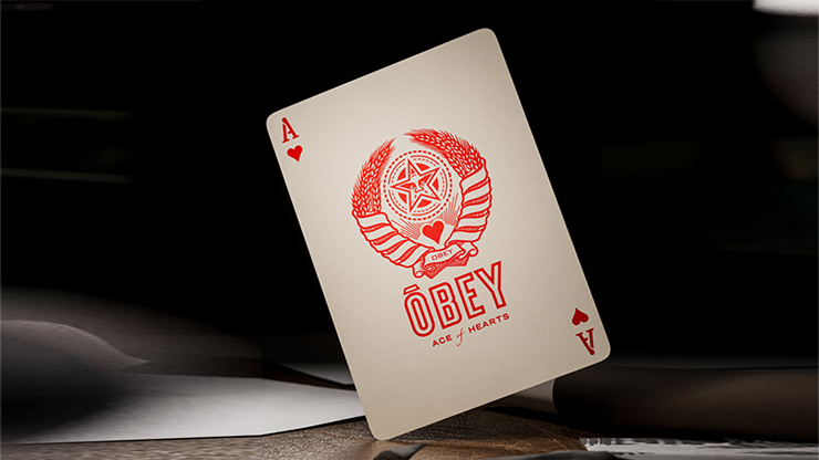Ace of Hearts card from Obey Red Edition playing cards by theory11 featuring the Obey star emblem on a dark studio background