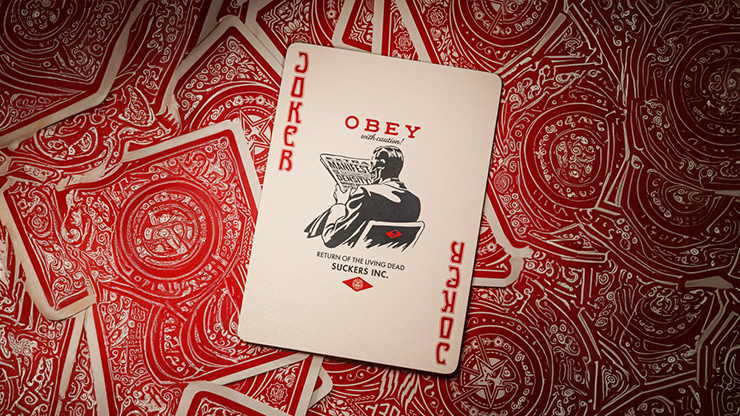 Obey Red Edition playing cards by theory11 featuring Joker card with Obey artwork displayed on a red patterned card background