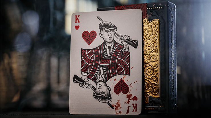 Peaky Blinders playing cards by theory11 featuring King of Hearts character card displayed beside the embossed collector tuck case on a dark cinematic background