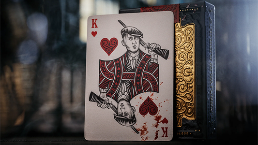 Peaky Blinders playing cards by theory11 featuring King of Hearts character card displayed beside the embossed collector tuck case on a dark cinematic background