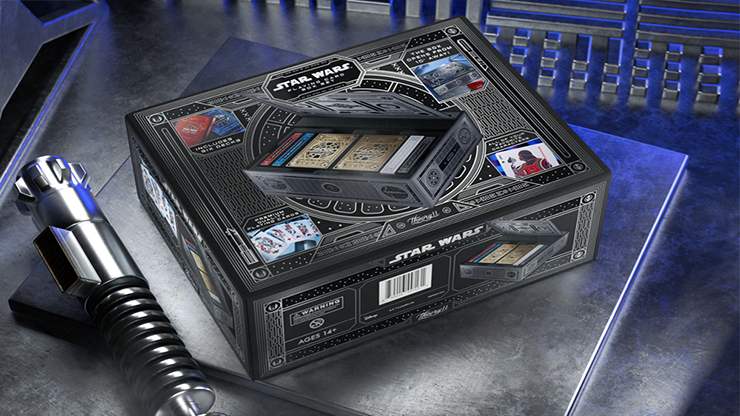 Star Wars playing cards box set by theory11 displayed with a lightsaber and collector packaging