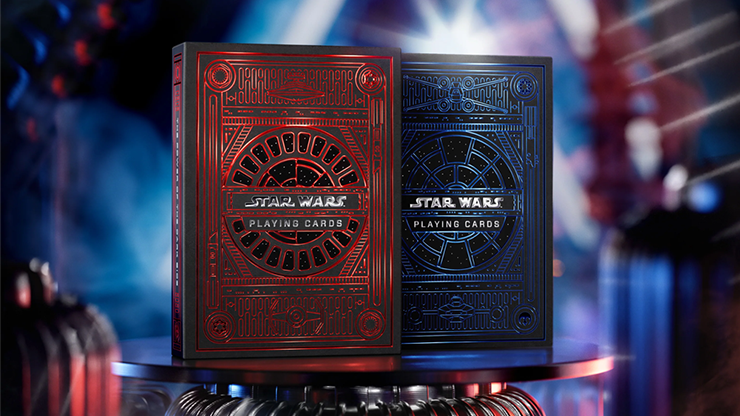 Red and blue Star Wars playing card decks by theory11 displayed on a metallic pedestal with cinematic sci-fi lighting