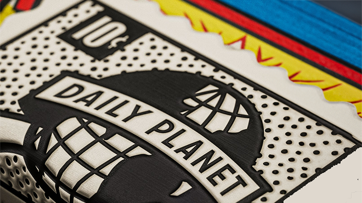 Close-up of Daily Planet logo from Superman playing cards by theory11 with comic-style colors and embossed design